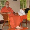 Devotee offering flowers at the Holy Lotus Feet